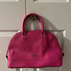Like new, pink Coach purse.   No rips, stains or tears.